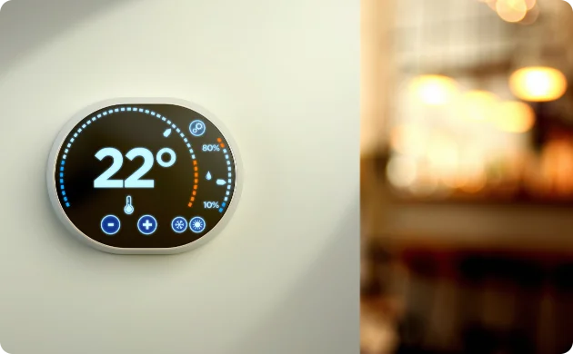 Modern wall-mounted smart thermostat with digital LED display for home climate control.
